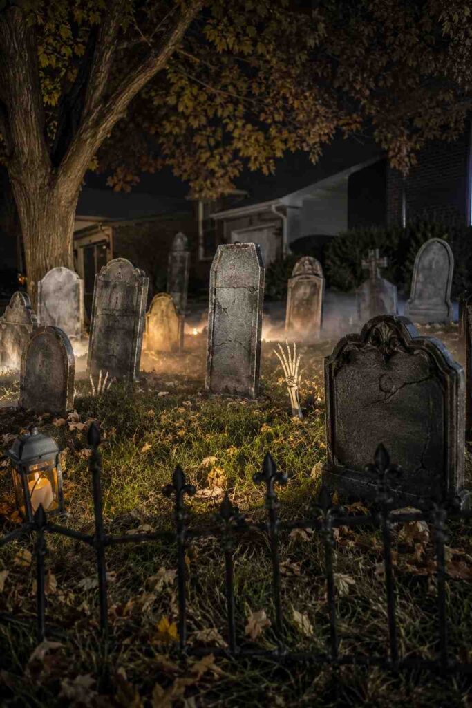 Top 20 Spooky Halloween Outdoor Ideas to Transform Your Yard This Fall 3 DIY Halloween graveyard with tombstones, skeleton hands, fog, and hidden LED lights