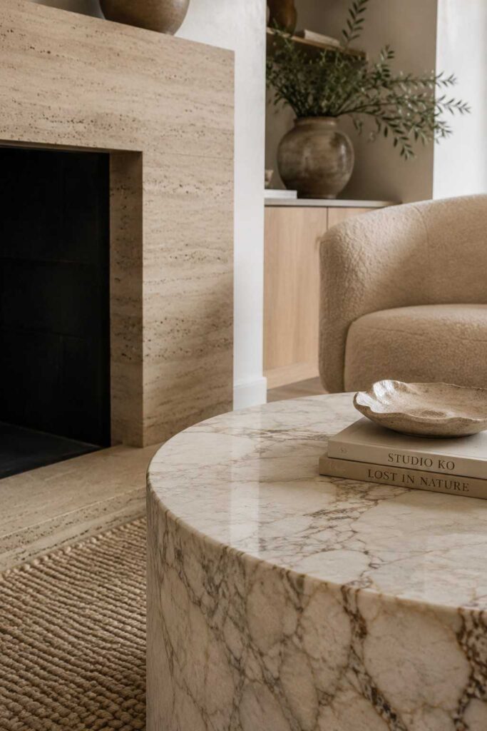 12 Luxury Beige Living Room Ideas for a Timeless, High-End Look 6 Marble coffee table and travertine fireplace in a beige living room