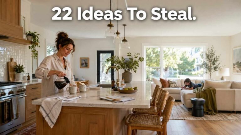 A woman pours coffee at a kitchen island in a bright open concept kitchen living room while a child does homework on the sofa behind her.