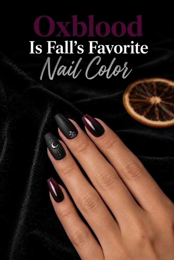Matte black coffin-shaped Halloween nails next to an oxblood ombre nail on the same hand.