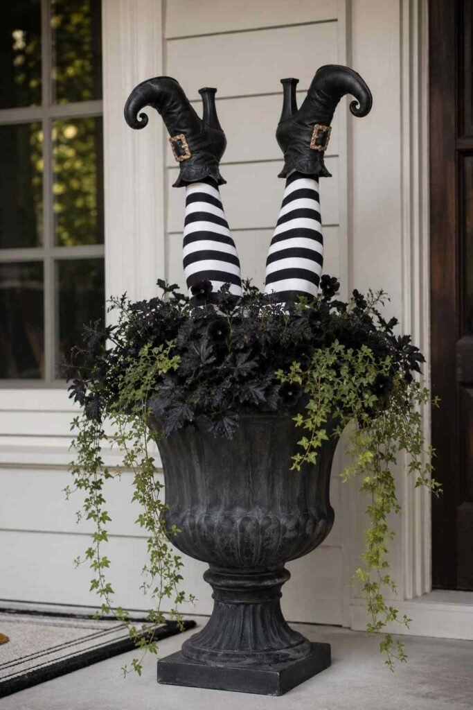 Halloween Planter Ideas to Turn Your Porch Into a Neighborhood Showstopper 7 Witch's legs Halloween planter on a front porch