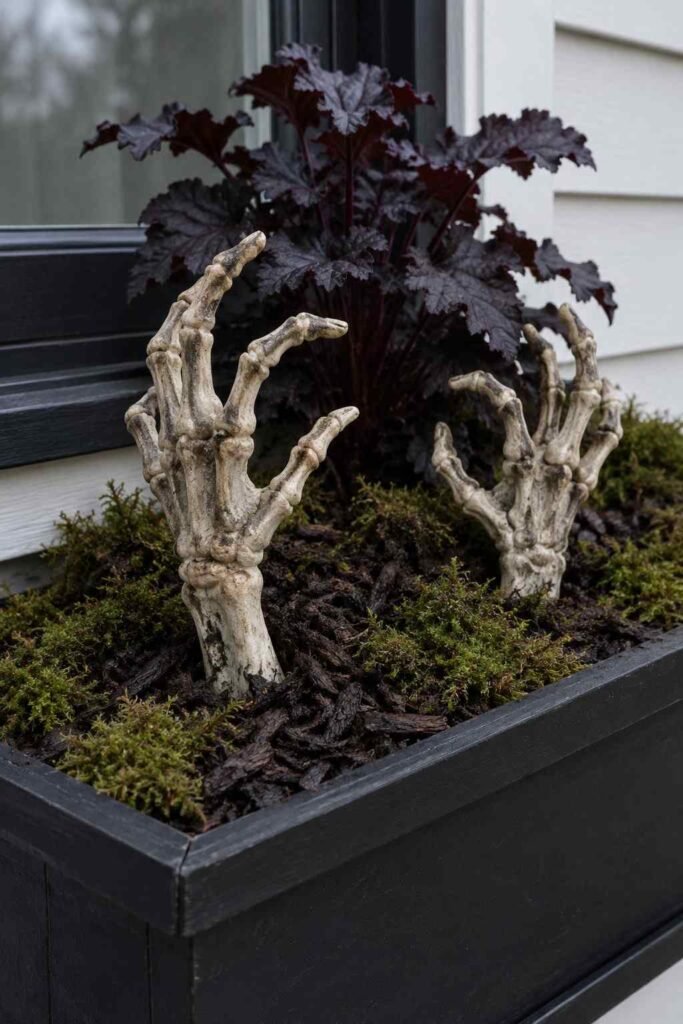Halloween Window Boxes: Spooky, Elegant & Budget-Friendly Ideas for Every Home 4 Skeleton hands rising from dark soil in a spooky Halloween window box