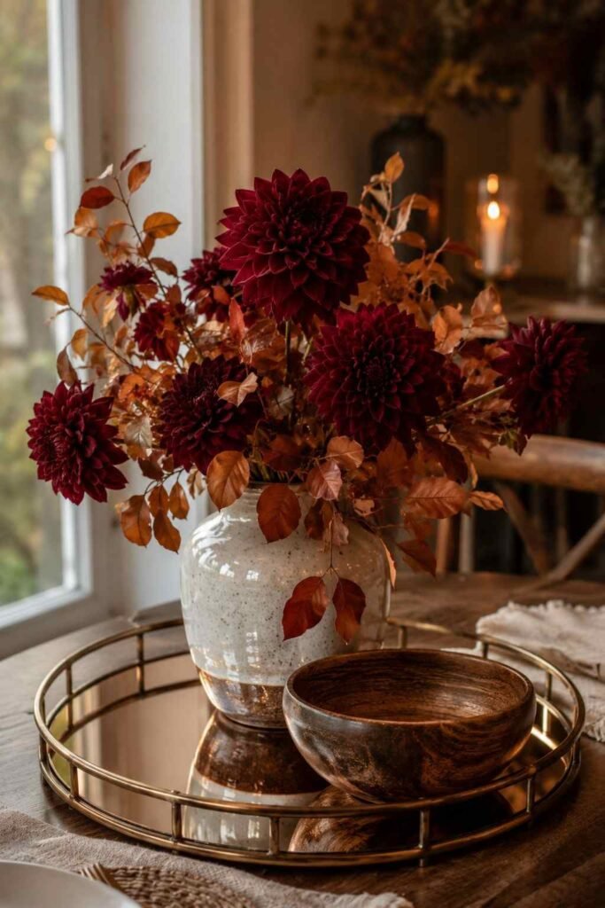27 Chic Mirror Table Decor with Fresh Flowers Ideas for Home, Weddings, and Parties 13 Burgundy dahlias and copper leaves on a bronze-tinted mirror tray with a wooden bowl