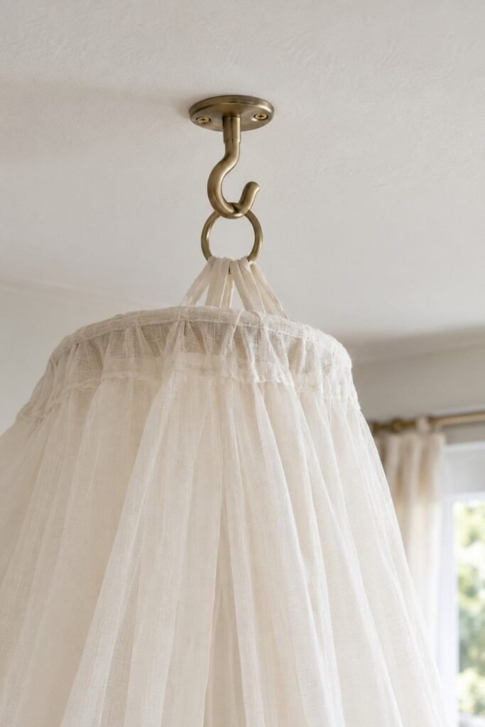 Close-up of a secure ceiling hook holding a canopy ring in a child's room.